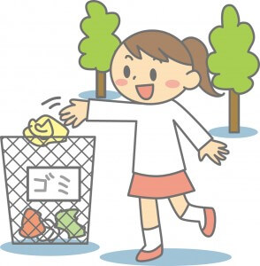 屋外でゴミ箱にゴミを捨てる女の子